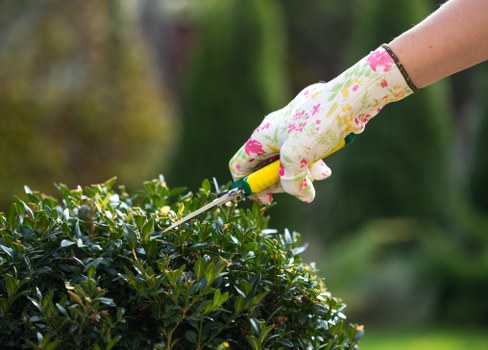 Workers following safe landscaping practices with tools and waste handling